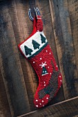 Christmas stocking hanging on wooden wall