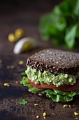 A wholemeal sandwich with avocado and egg salad, and tomatoes