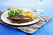 Beef steaks with lettuce and apple