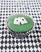 A cupcake decorated with playing cards