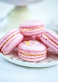 Pink macaroons filled with raspberry jam and clotted cream (close-up)