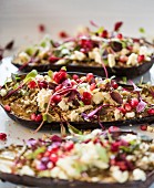 Stuffed aubergines with feta cheese and pomegranate seeds