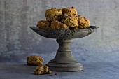 Spelt scones with raisins and cranberries on a grey, antique stand