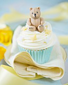 A cupcake decorated with a fondant teddy bear