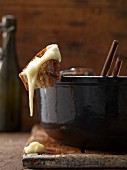 Cheese fondue with a piece of bread