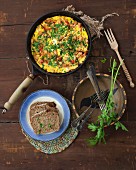 Omelette with ham, bread and parsley (seen from above)