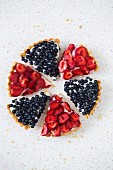A circle of strawberry and blueberry tart slices