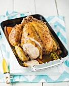 Roast chicken on a bed of vegetables with apple wine