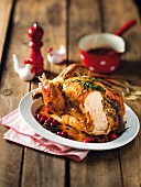 Roast chicken with a sausage meat and cranberry filling