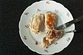 Fried pierogi (Polish meat dumplings) on a floral patterned plate