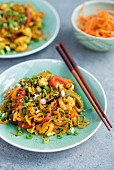 Fried carrot noodles with chicken, prawns and vegetables (Asia)