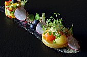 Artichokes with melon balls and cress, radishes and blueberries