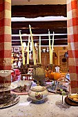 Cake stand, soup tureen and candelabra on crammed table