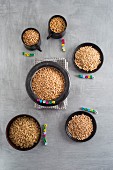 Various types of grains in cups and bowls