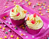 Colourful cupcakes decorated with lime frosting and sweets