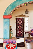 View of ethnic-style foyer through brightly painted archway