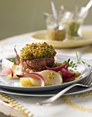 Pork medallions with a wild herb crust on May turnips in orange