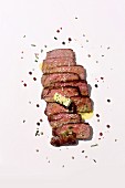 Sliced medium beefsteak with herb butter and spices
