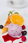 Blueberry ice cream with candied oranges on a lemon tart