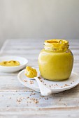 Dijon mustard with a spoon and mustard seeds