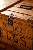 Detail of wooden crate with simple catch and black stencilled label