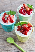 Three cups of vanilla quark with strawberries, mint sprigs and mint sugar