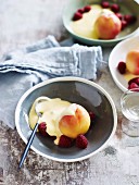 Poached peaches and raspberries with prosecco zabaglione