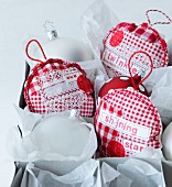 Hand-sewn patchwork Christmas tree decorations made from various red and white patterned fabrics