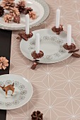 Advent arrangement of copper candle clips on porcelain plate