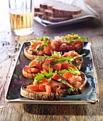 Bruschetta topped with tomato and rocket