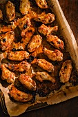 Crispy chicken wings on a baking tray