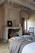 Antique marble fireplace and coffered ceiling in bedroom