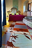 Bed with Baroque headboard against marbles wall and sofa on painted wooden floor