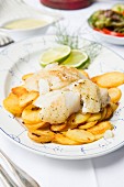 Fried fish with fried potatoes and mushroom sauce