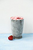Homemade strawberry ice cream in a metal cup
