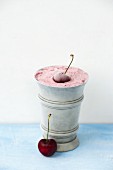 Homemade cherry ice cream in a metal cup