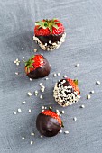 Chocolate-coated strawberries and chopped almonds