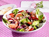 A colourful salad with shrimps, strawberries and radishes