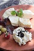 Cream cheese with black sesame seeds, feta cheese, olives and raspberries
