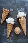 Two ice creams in cones with empty cones
