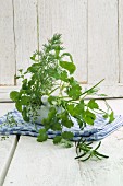 Various fresh herbs in a mortar