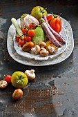 An arrangement of vegetables featuring aubergines, tomatoes, leek and mushrooms