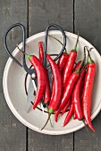Red chilli peppers and a pair of herb scissors
