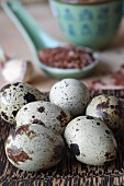 Quails eggs with a porcelain spoon of red rice in the background