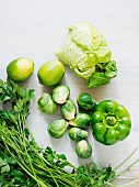 An arrangement of green vegetables and lemons