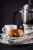 A chocolate croissant and a cup of coffee