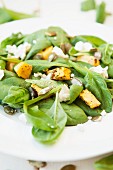 Spinach salad with pumpkin, feta cheese and pumpkin seeds