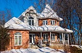 Red brick Victorian-style home in winter, Quebec, Canada