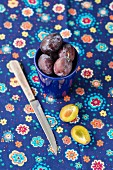 Damsons in a blue cup