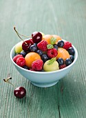 Fruit salad with berries, melon balls and cherries